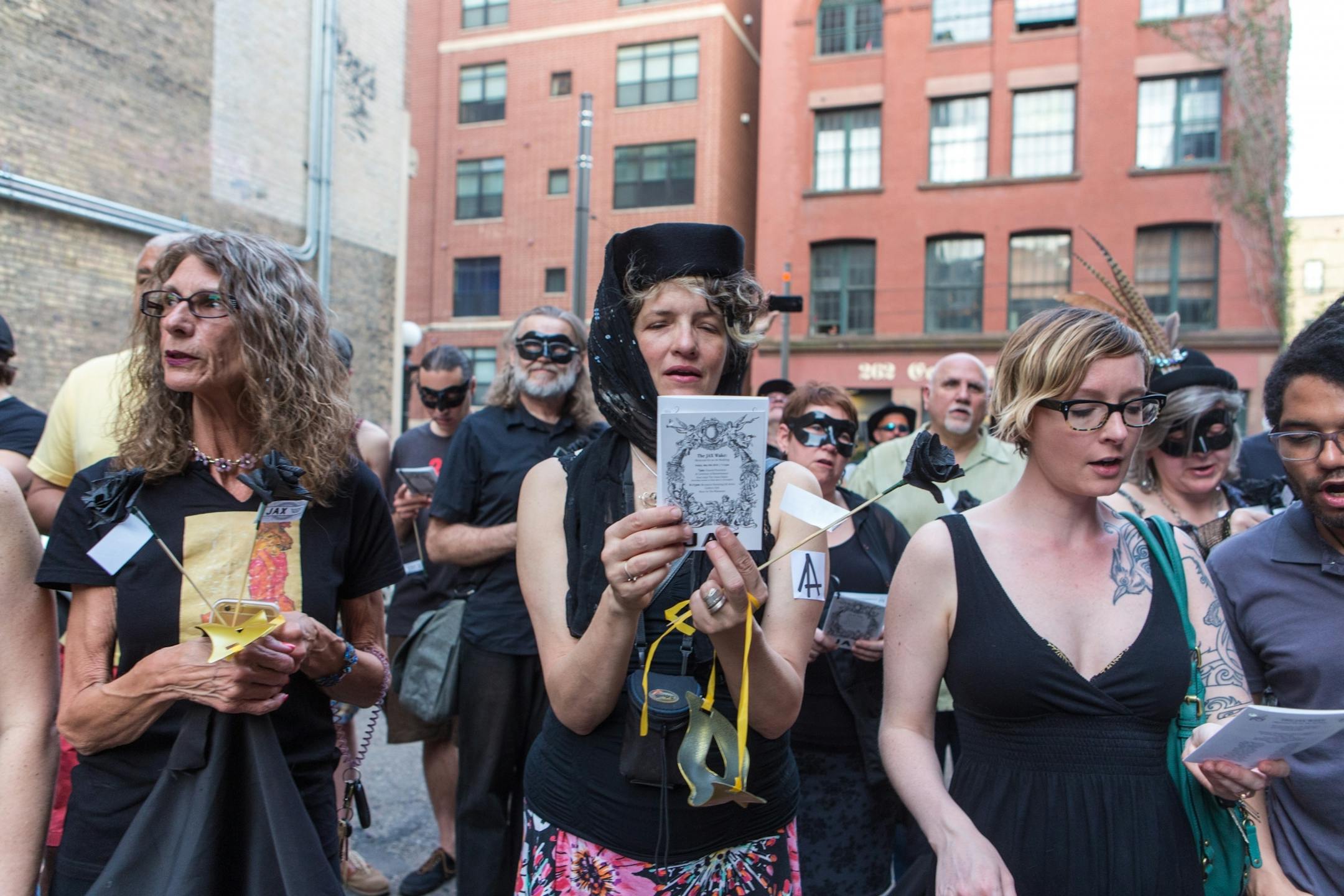 Former Jax building tenants and Lowertown arts supporters read a eulogy in honor of the building in the alley of the Jax Building Friday evening.