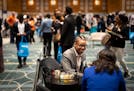 Jerome Riley networks and gets some mentorship from a U.S. Bank representative during the annual People of Color Career Fair at the Minneapolis Conven