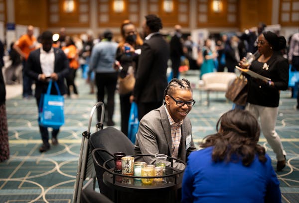 Jerome Riley networks and gets some mentorship from a U.S. Bank representative during the annual People of Color Career Fair at the Minneapolis Conven