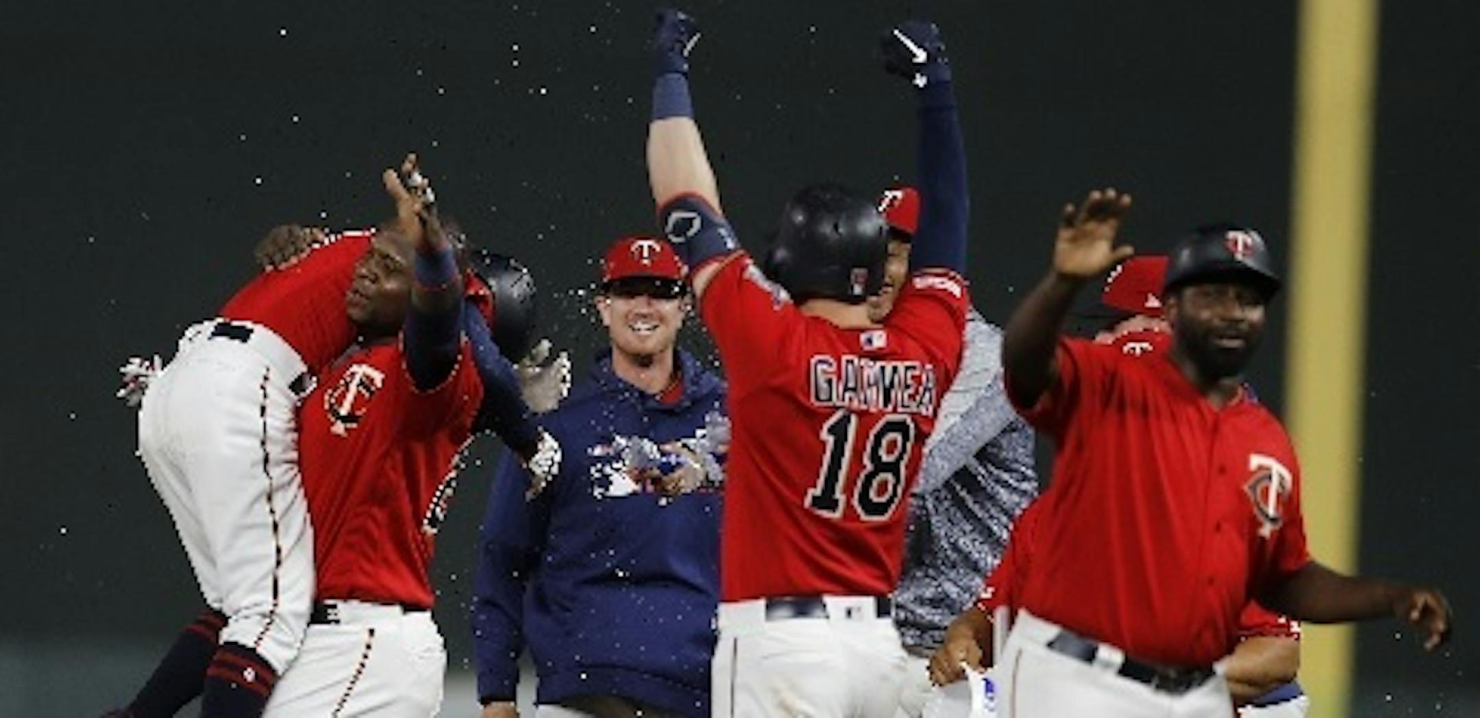 Twins third baseman Miguel Sano carried teammate Ronald Torreyes, left, after Torreyes was hit by a pitch in the 12th inning to force in the winning run in a 9-8 victory over the White Sox at Target Field on Tuesday night.