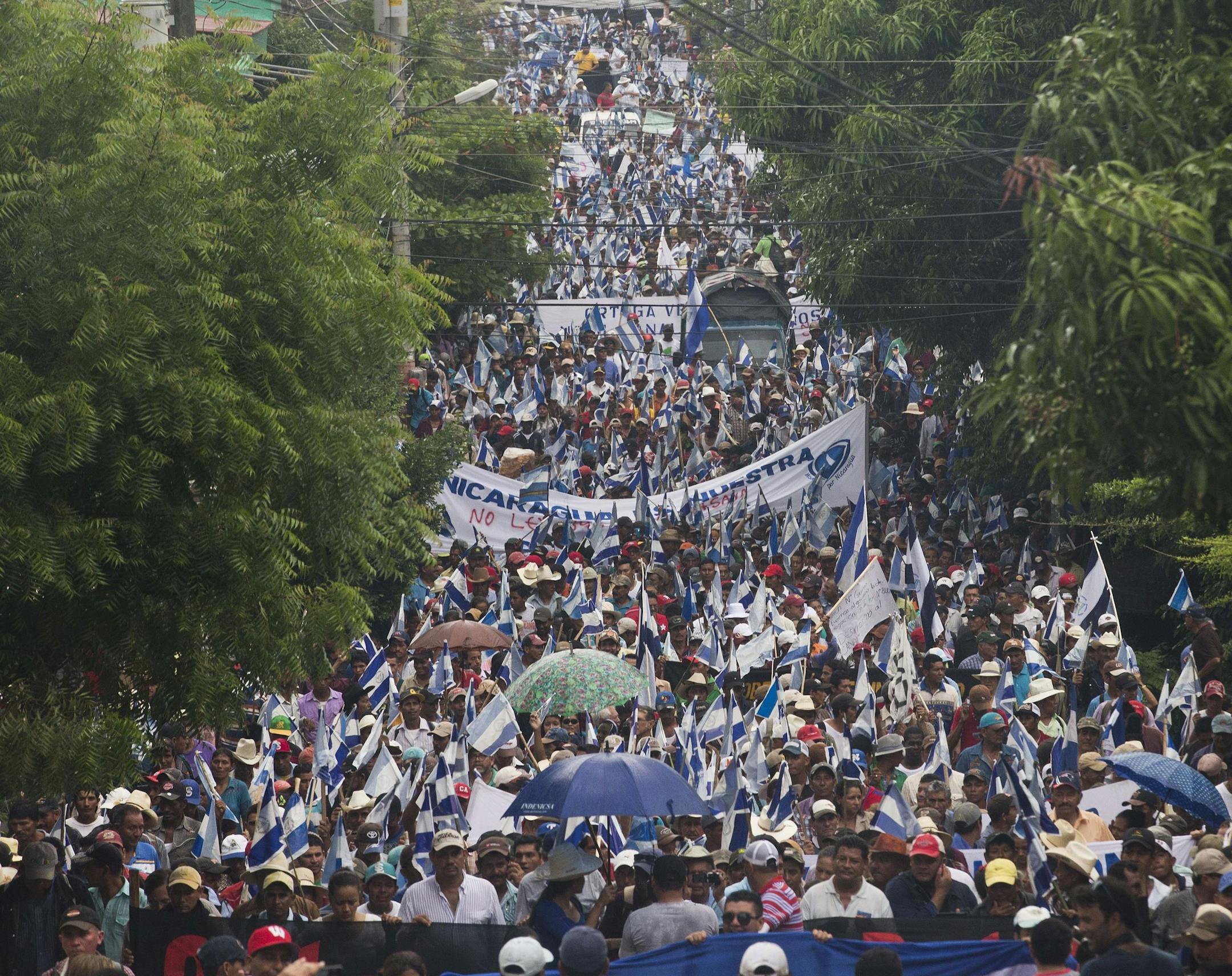 Opponents to the construction of Nicaragua's transoceanic canal take part in a national protest march against the canal project, in Juigalpa, Nicaragua, Saturday, June 13, 2015. (AP Photo/Esteban Felix)