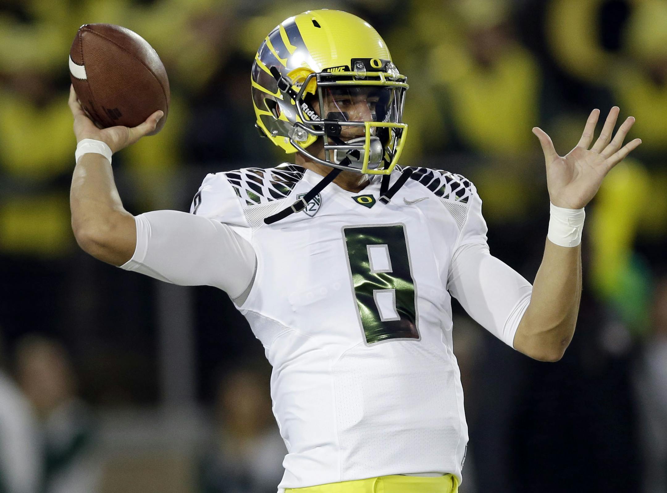 Oregon quarterback Marcus Mariota warms up before an NCAA college football game against Stanford, Thursday, Nov. 7, 2013, in Stanford, Calif. (AP Photo/Marcio Jose Sanchez)