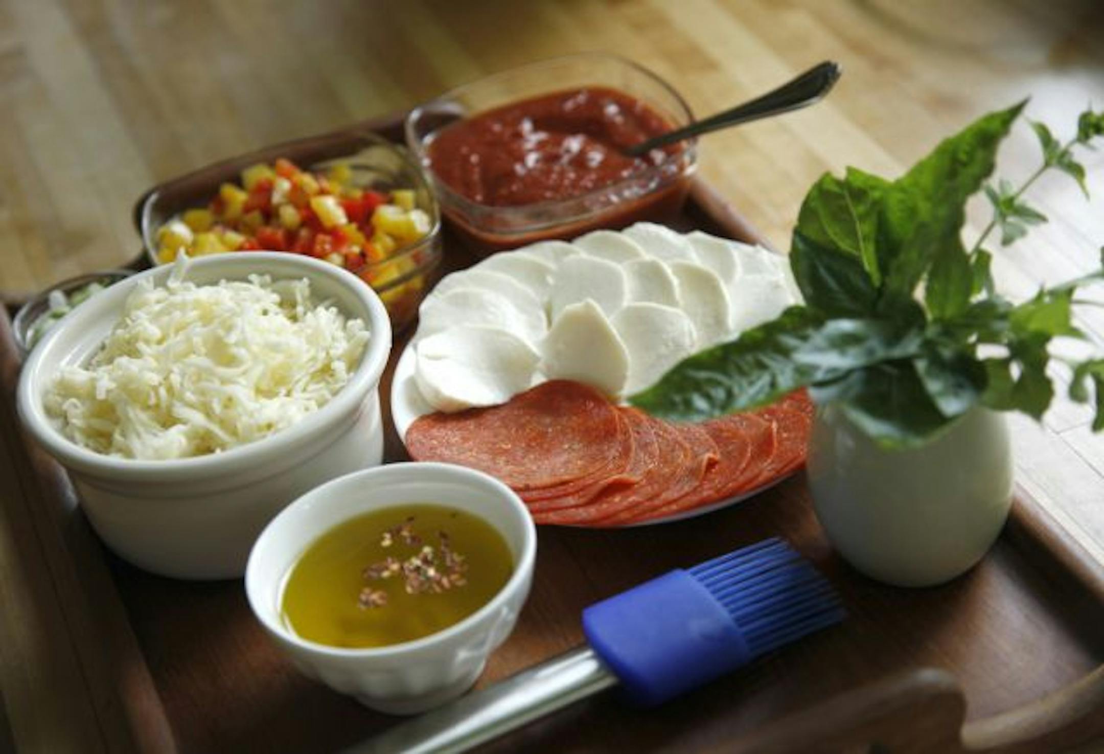 Have all the toppings ready so pizzas can be quickly assembled once the crusts are off the grill.