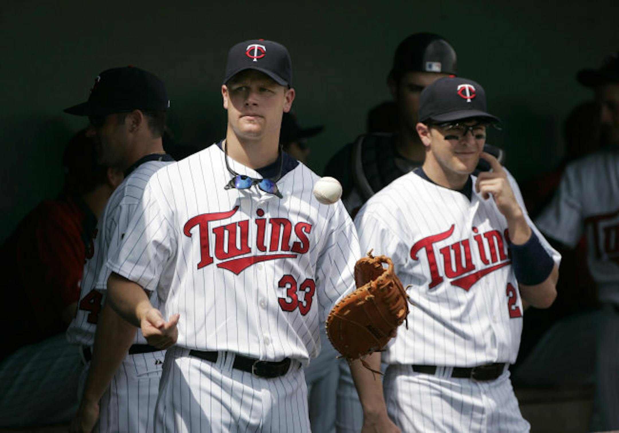 Justin Morneau (33) stood with Brendan Harris before the start of Monday's game against Cincinnati in Fort Myers, Fla.