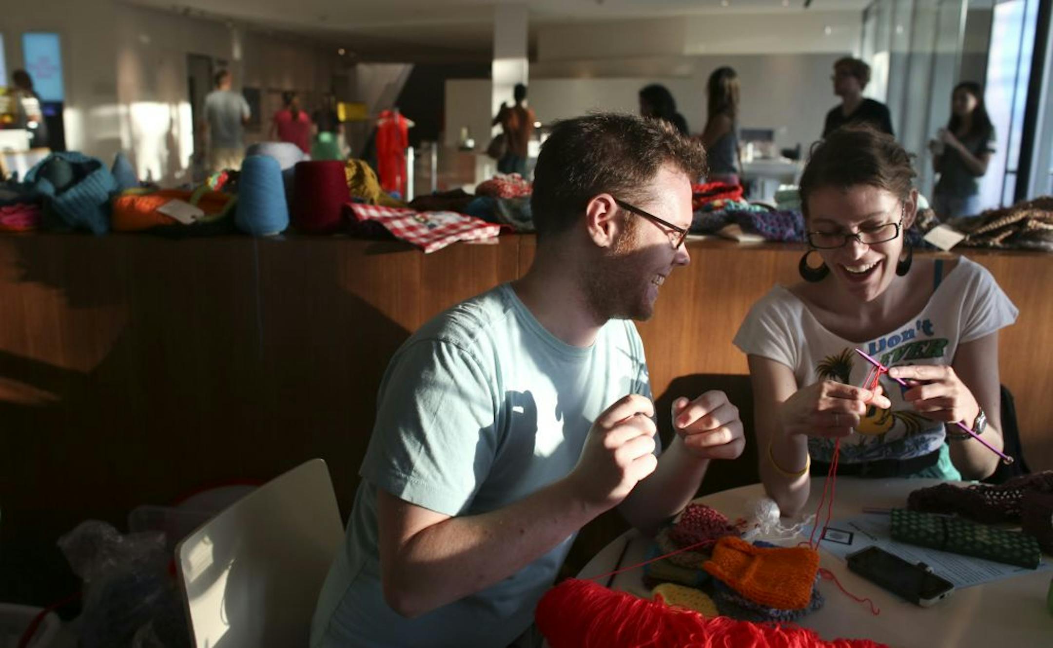 Megan Burton of Minneapolis showed Scott Artley, also of Minneapolis, how to start a project during the Swatch Team's knitting time at Walker Arts Center.