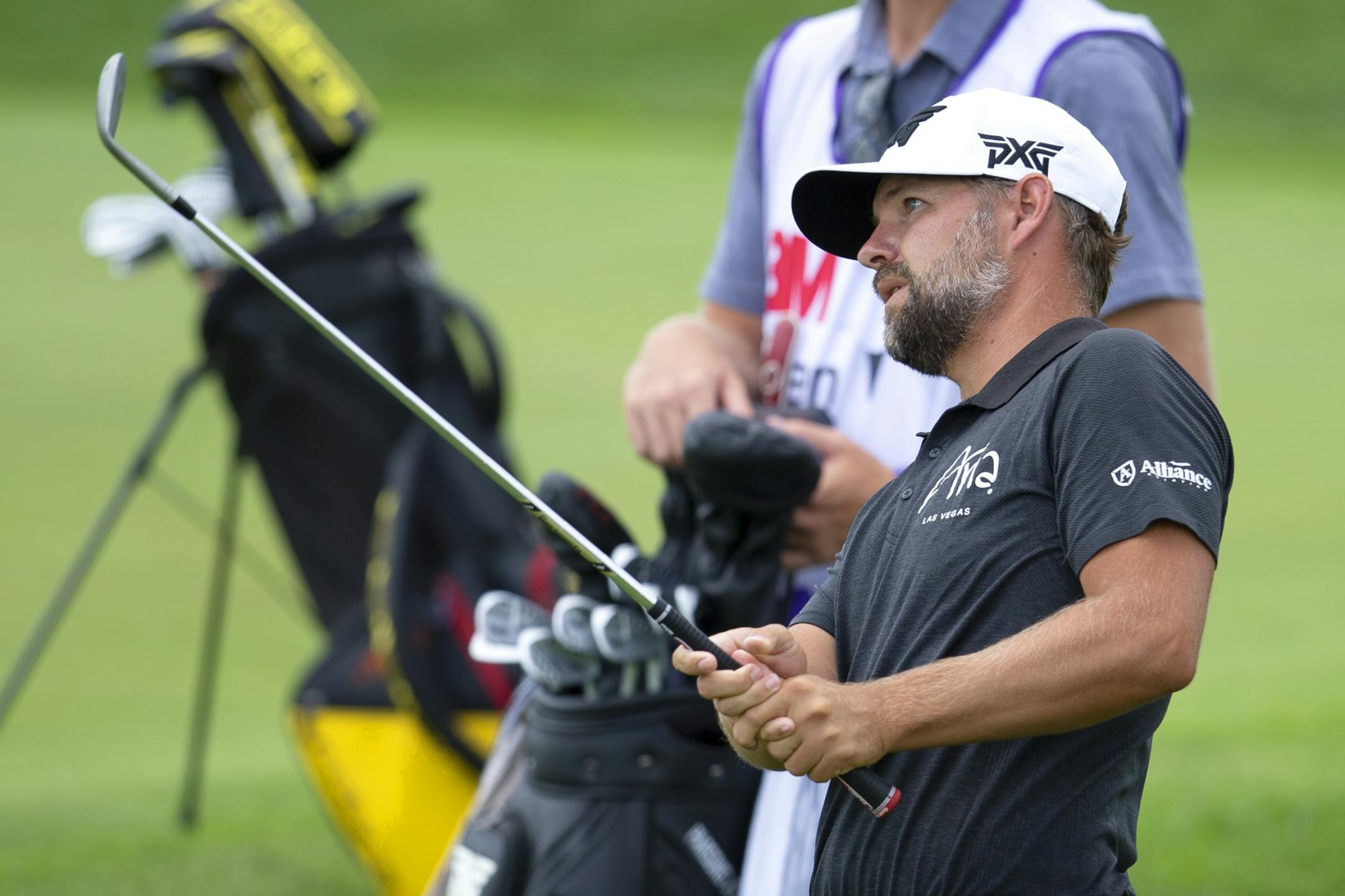 Ryan Moore watches his shot on the 18th hole during the first round of the 3M Open golf tournament in Blaine, Minn., Thursday, July 23, 2020.