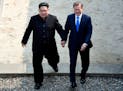 FILE - In this Friday, April 27, 2018, file photo, North Korean leader Kim Jong Un, left, and South Korean President Moon Jae-in cross the military de