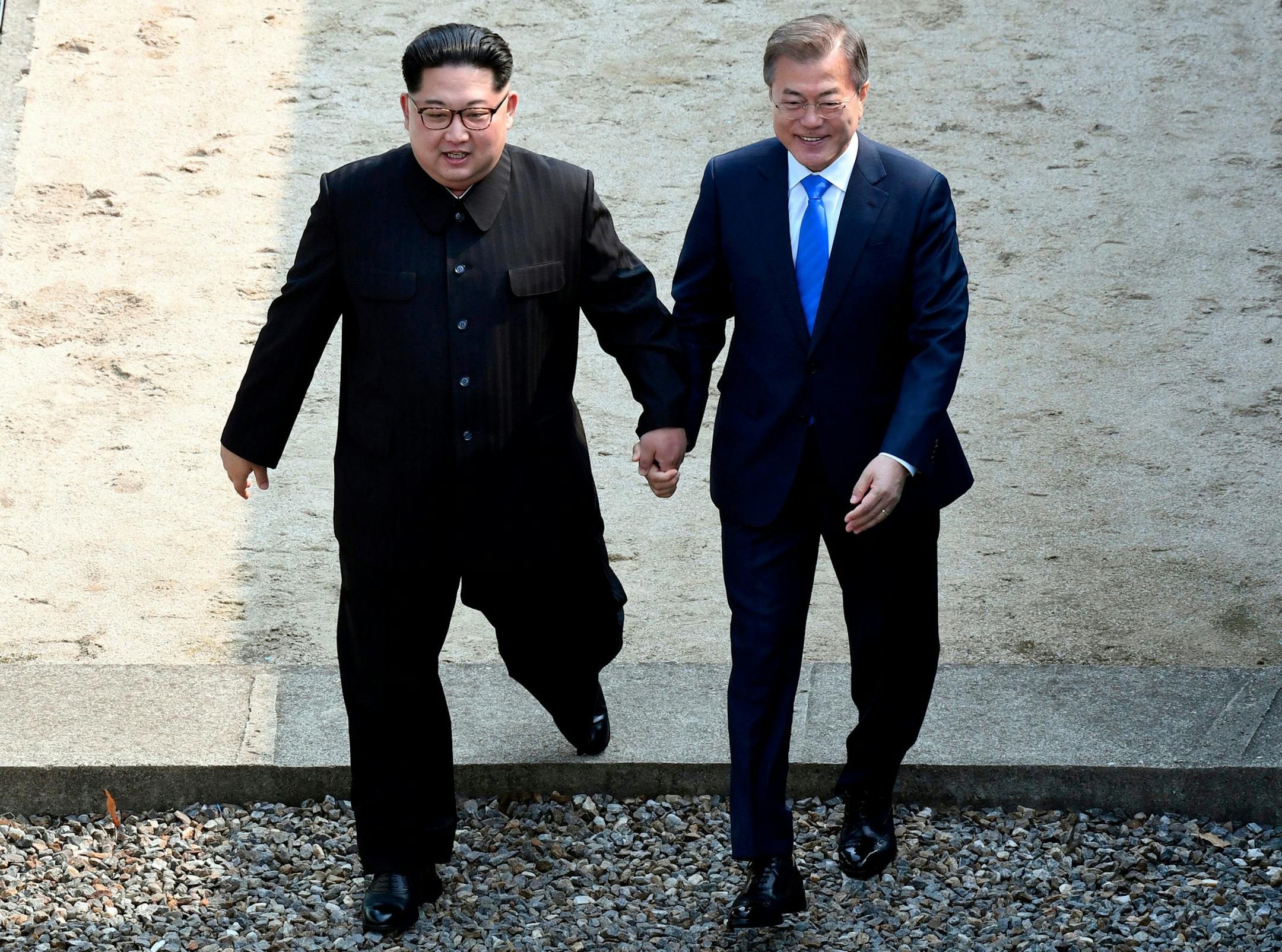 FILE - In this Friday, April 27, 2018, file photo, North Korean leader Kim Jong Un, left, and South Korean President Moon Jae-in cross the military demarcation line at the border village of Panmunjom in Demilitarized Zone, South Korea. Kim became the first North Korean leader to set foot onto South Korean land since the 1950-53 Korean War when he stepped into the southern side of the border village of Panmunjom to meet with Moon Jae-in on Friday. (Korea Summit Press Pool via AP, File)