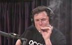 Elon Musk, chairman and CEO at Tesla and chairman of SpaceX, inhales what he said was marijuana on a live YouTube webcast Thursday night.