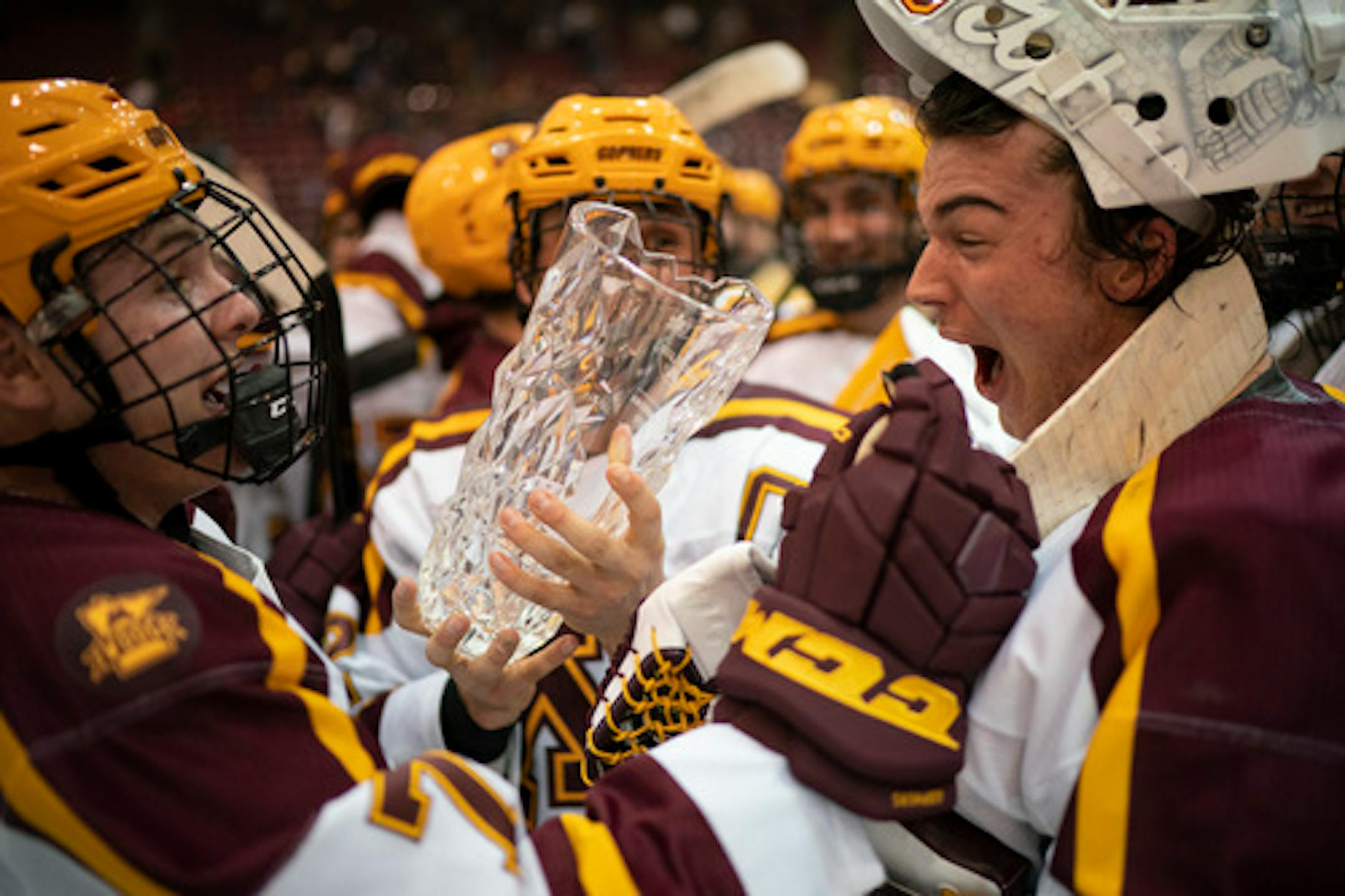 Minnesota Gophers forward Brannon McManus, left, handed the trophy to goalie Jack LaFontaine after the Gophers' Mariucci Classic win.    ]   JEFF WHEELER • Jeff.Wheeler@startribune.com