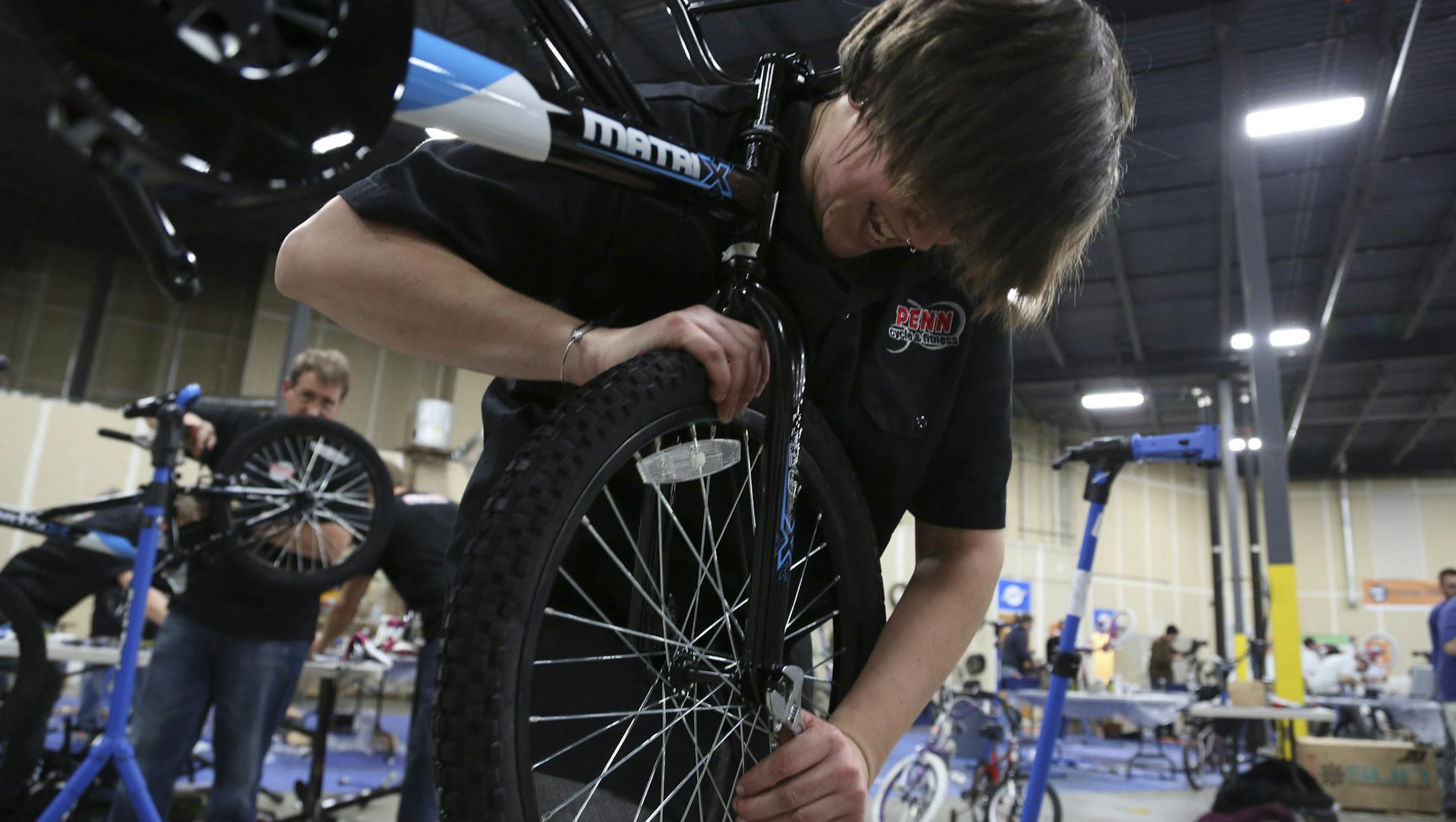 Vanessa Schroeder, of Penn Cycle, tightened the wheels on a bike for Free Bikes 4 Kidz in Hopkins, Min., Wednesday November 28, 2012. This was Battle of the Bike Shops in which teams of mechanics representing Twin Cities bike stores scrambled to see which one can assemble the most bikes. ] (KYNDELL HARKNESS/STAR TRIBUNE) kyndell.harkness@startribune.com ORG XMIT: MIN1211291851120084