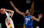 United States' Kevin Durant (7), right, tries to block Spain's Ricky Rubio (9), left, during men's basketball quarterfinal game at the 2020 Summer Oly