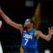 United States' Kevin Durant (7), right, tries to block Spain's Ricky Rubio (9), left, during men's basketball quarterfinal game at the 2020 Summer Oly