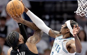 Jaden McDaniels of the Timberwolves blocks Dereck Lively II in the first quarter during Game 2 of the Western Conference finals at Target Center.