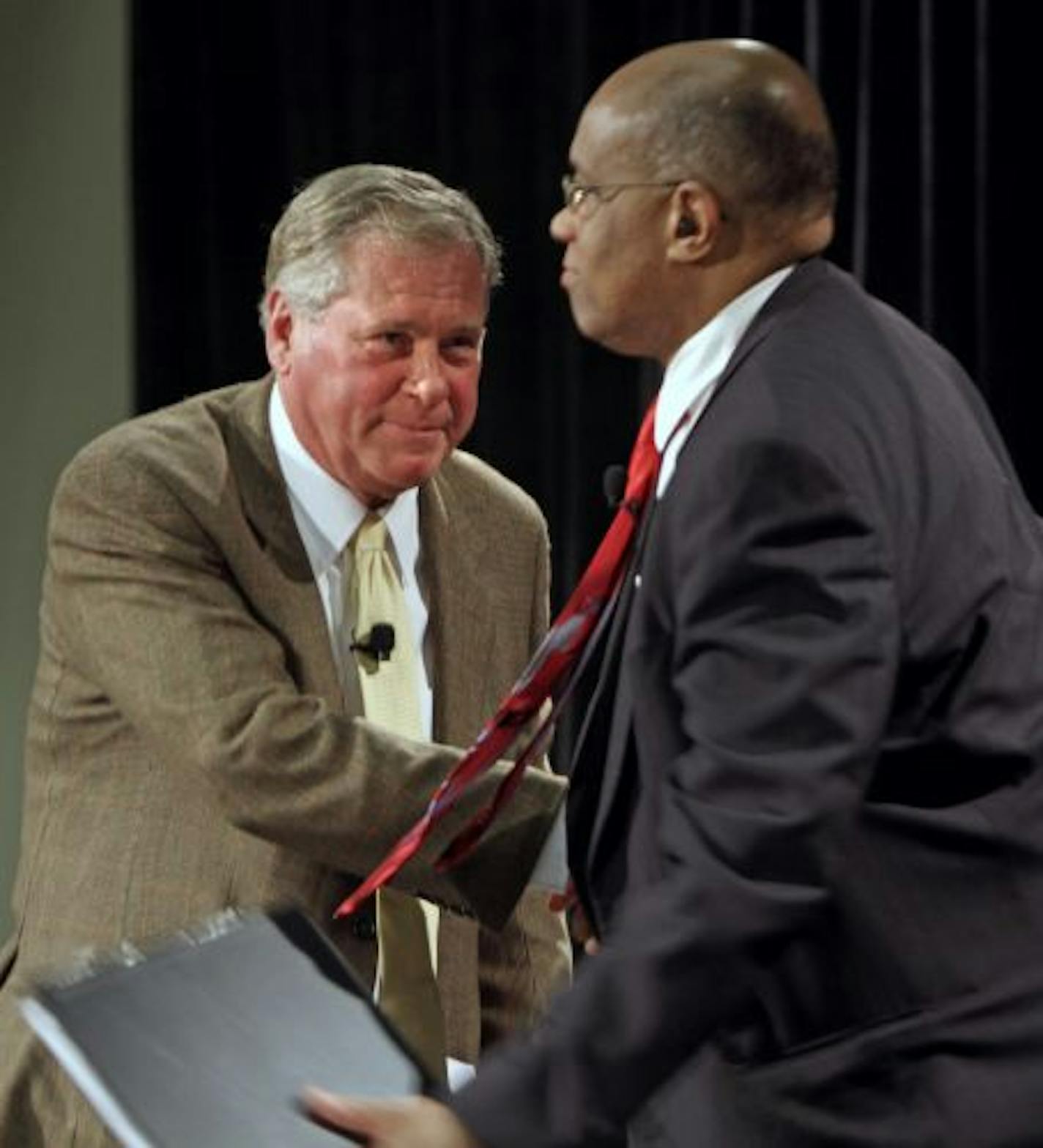 David Logan, left, a former public official and CEO who served time for taking bribes, shook the hand of Judge Michael Davis, who sentenced Logan to 71 months in prison.