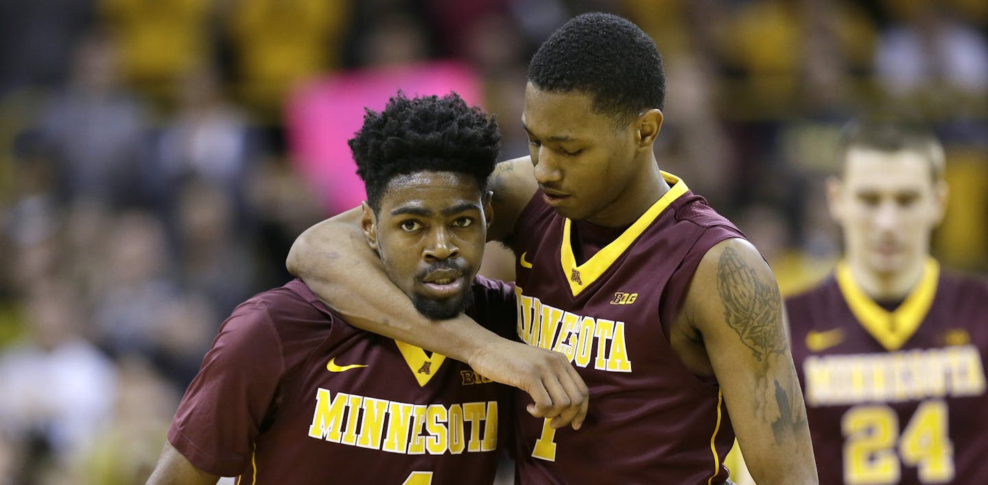 Minnesota's Kevin Dorsey, left, talks with teammate Dupree McBrayer during the second half of an NCAA college basketball game against Iowa, Sunday, Feb. 14, 2016, in Iowa City, Iowa. Iowa won 75-71. (AP Photo/Charlie Neibergall)