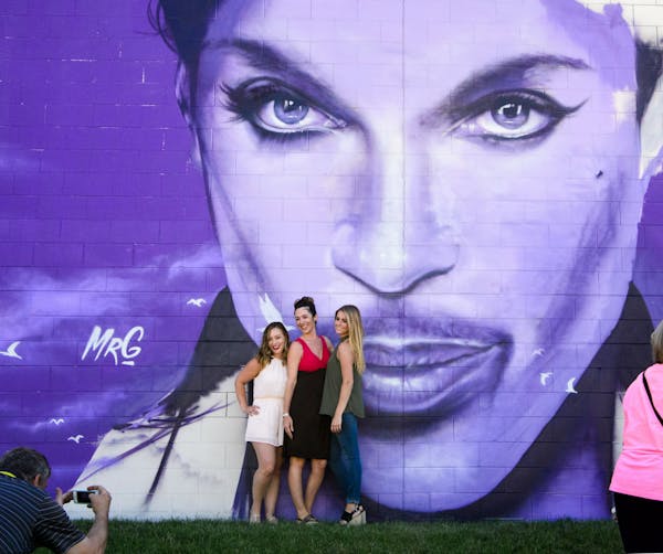 Rachel Omodt, Mandy Lindberg and Paige Wilson posed for a photo by the Prince mural.