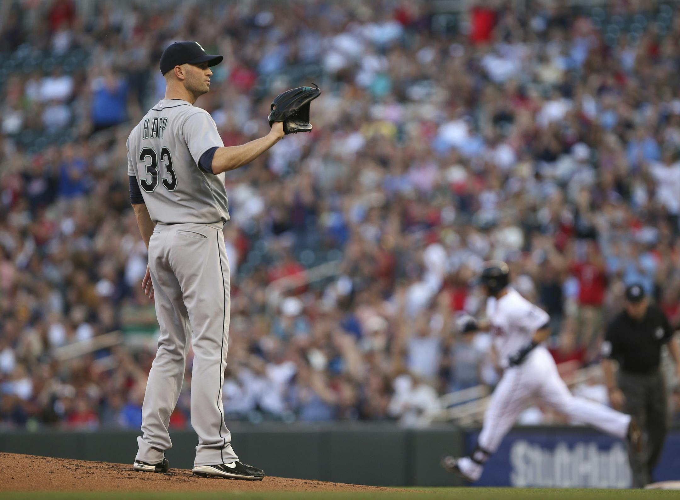 Twins leadoff hitter Brian Dozier rounded first after he homered off Seattle's J.A. Happ in the first inning Thursday evening. ] JEFF WHEELER ï jeff.wheeler@startribune.com The Minnesota Twins began a series with the Seattle Mariners Thursday night, July 30, 2015 at Target Field in Minneapolis.