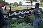 Minneapolis Park and Recreation Board (MPRB) workers install new placards changing East and West Lake Calhoun Parkways to East and West Bde Maka Ska P