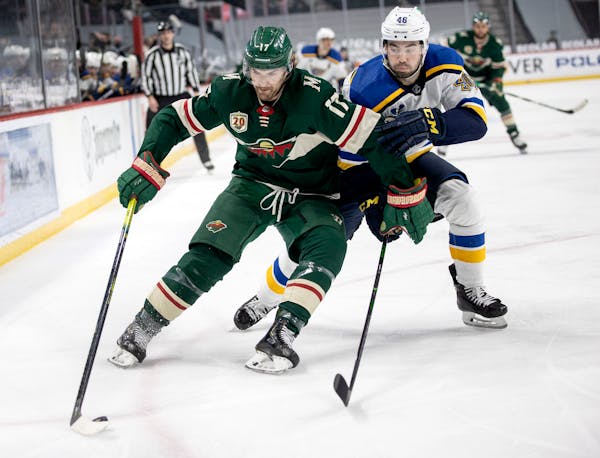 Marcus Foligno (17) of the Minnesota Wild and Jake Walman (46) of the St. Louis Blues fought for the puck in the first period.
