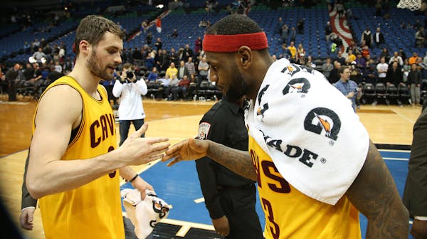 Cavaliers Kevin Love and LeBron James slap five after their win against the Wolves before heading got the locker room., at the Target Center in Minnea
