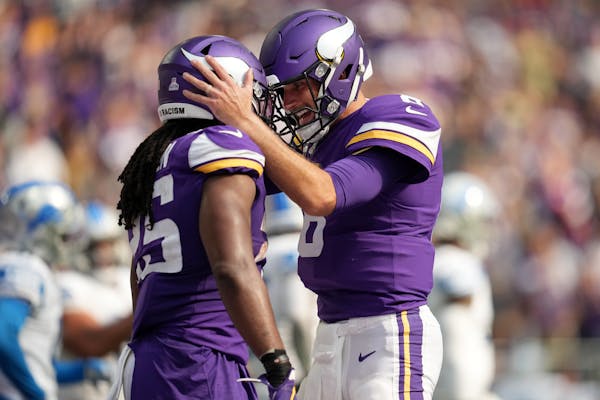 Vikings quarterback Kirk Cousins (8) and running back Alexander Mattison celebrate Mattison’s second-quarter touchdown. 