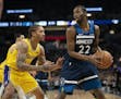 Minnesota Timberwolves forward Andrew Wiggins (22) looked to pass while guarded by Los Angeles Lakers forward Michael Beasley (11) in the first quarte