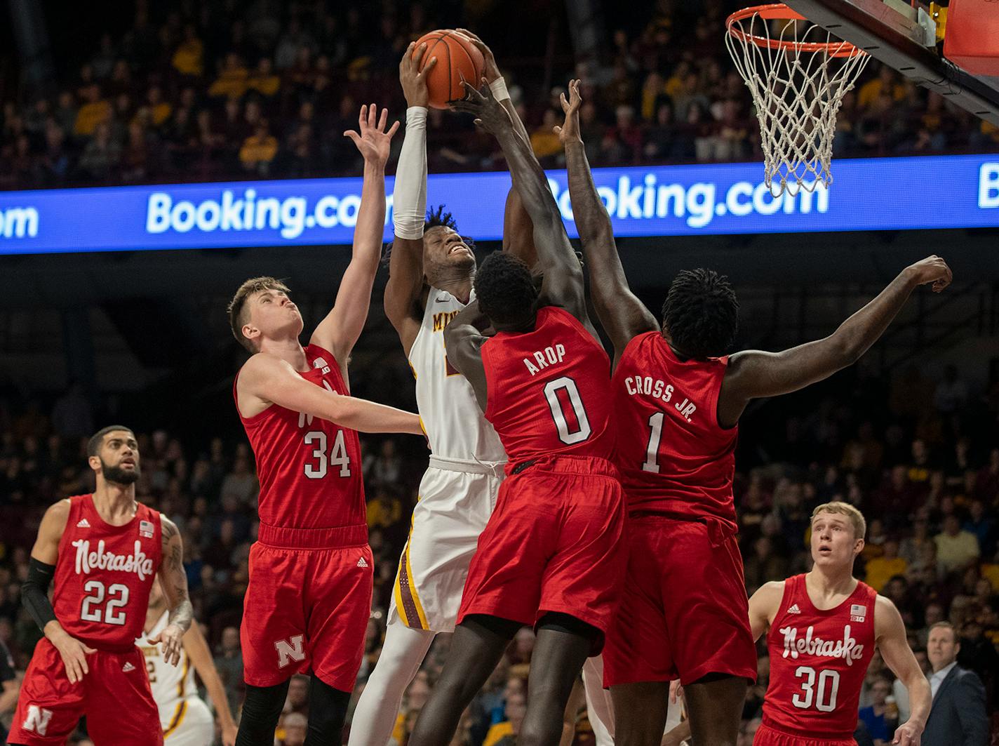 Minnesota Gophers center Daniel Oturu (25) rebounded and scored over Nebraska defenders this season.