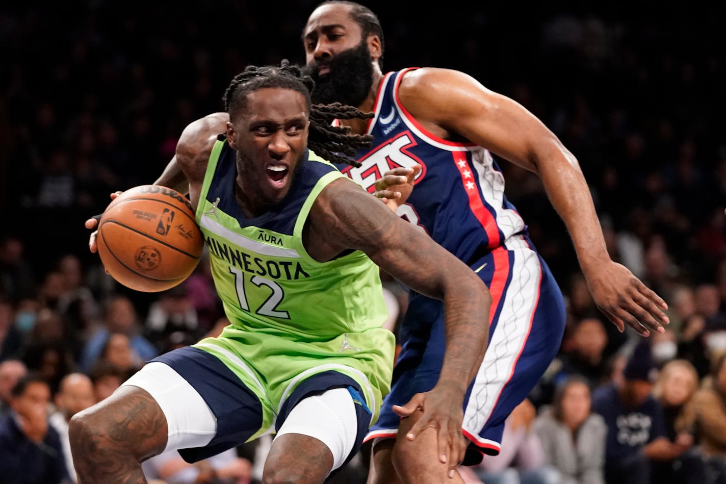 Timberwolves forward Taurean Prince drives against Brooklyn guard James Harden during the first half