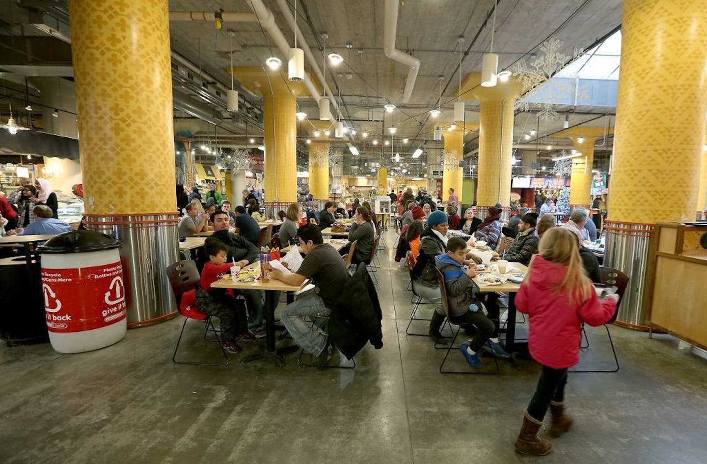 People made their way in and around the different food vendors during the lunch hour at the Midtown Global Market, Thursday, December 22, 2016 in Minneapolis, MN.