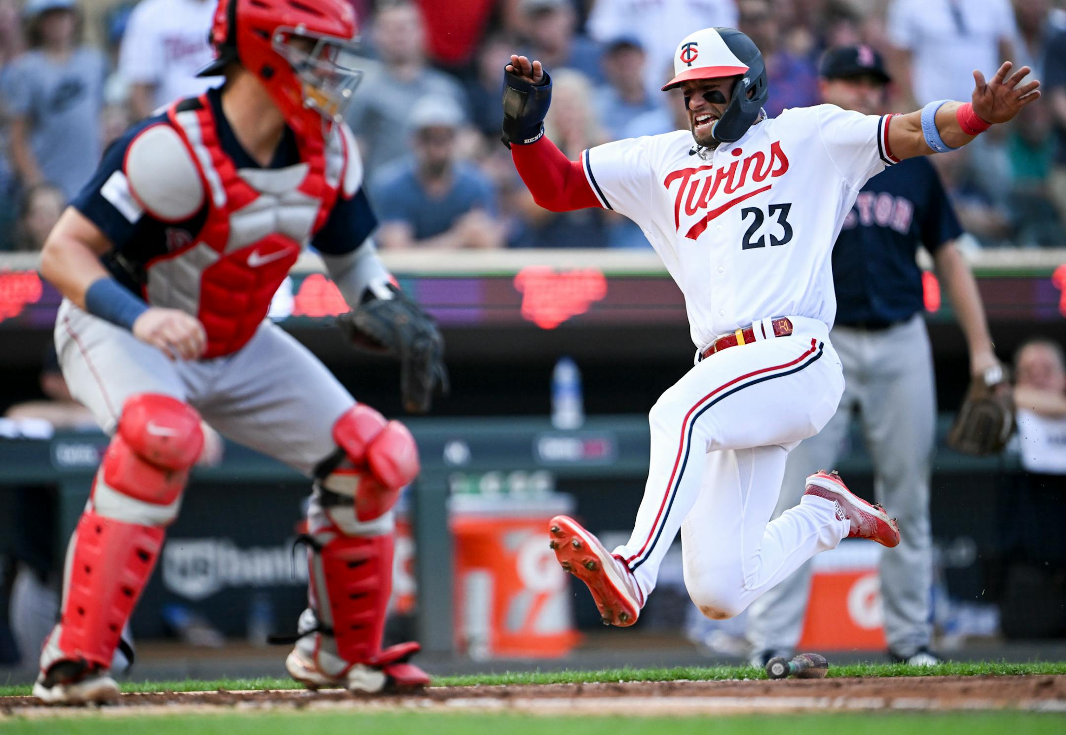 Minnesota Twins third baseman Royce Lewis (23) slides home safely after a single hit by catcher Christian Vazquez (8) in the bottom of the second inning against the Boston Red Sox Wednesday, June 21, 2023, at Target Field in Minneapolis, Minn.