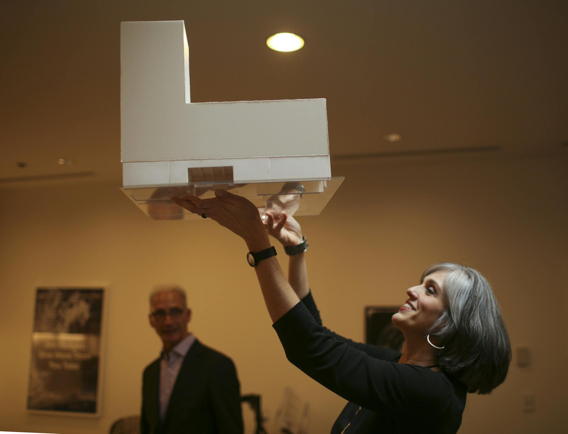 Walker Art Center director Olga Viso held up an architect's model to show renovations to the museum's Barnes building in 2015. With her at left was architect John Cook of HGA.