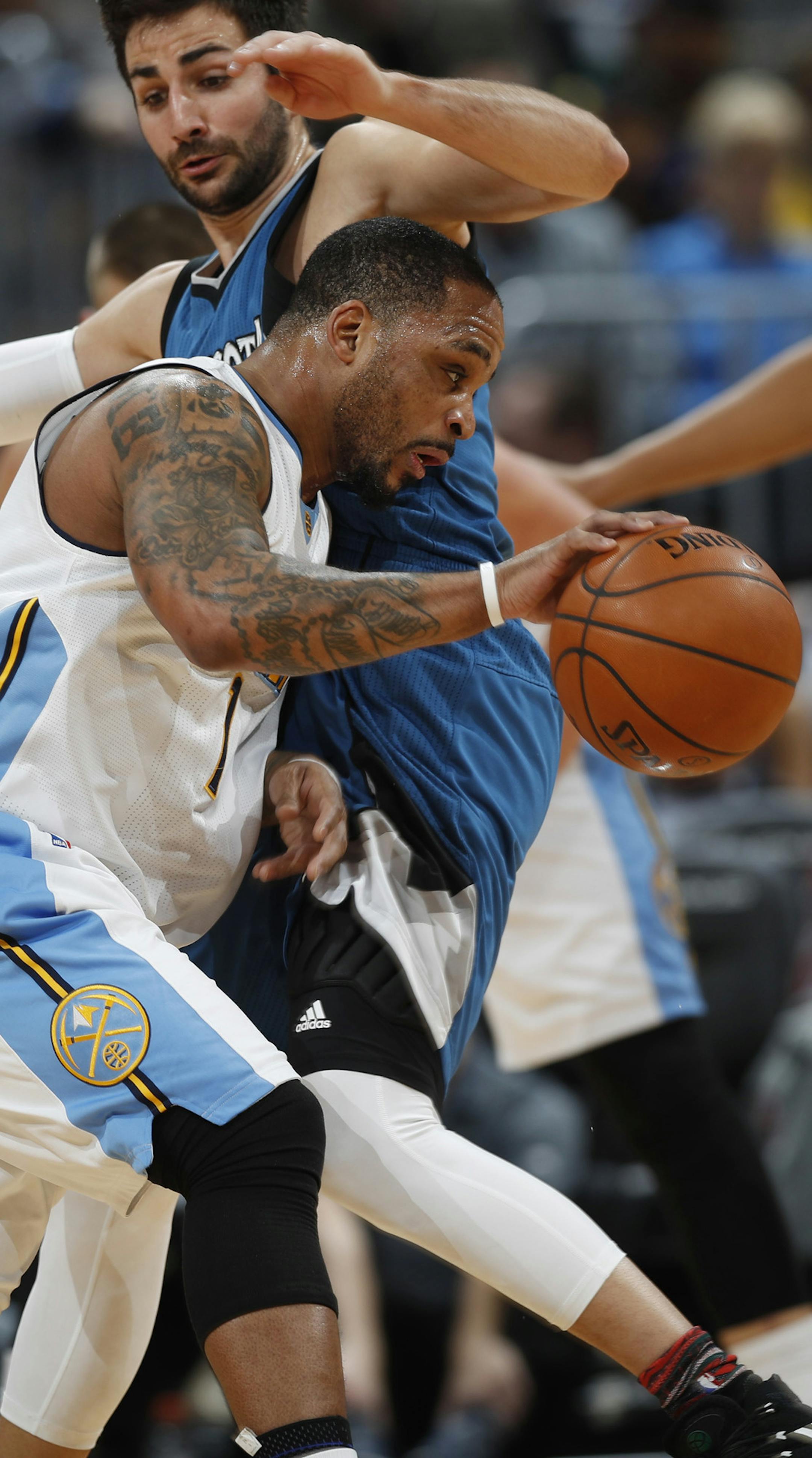 Denver Nuggets guard Jameer Nelson, front, runs into Minnesota Timberwolves guard Ricky Rubio, of Spain, in the first half of an NBA basketball game, Wednesday, Feb. 15, 2017, in Denver. (AP Photo/David Zalubowski)