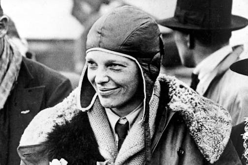 FILE - American aviatrix Amelia Earhart poses for photos as she arrives in Southampton, England, after her transatlantic flight on the "Friendship" from Burry Point, Wales, June 26, 1928. A leather helmet that Amelia Earhart wore on a flight across the Atlantic in 1928 and later lost in a crowd of fans in Cleveland, sold at auction for $825,000, Heritage Auctions said. (AP Photo/File)