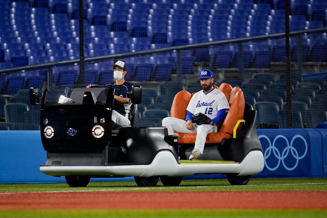 Israel's Shlomo Lipetz comes in to pitch on the bullpen cart.
