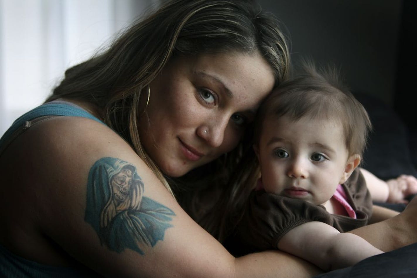 Sabrina Gorr held her daughter Georgia-Bella Gorr, 8 months, at her St. Paul home. Gorr, who recently changed her Virgin Mary tattoo into an image of Santa Muerte, or the saint of death, didn't realize it would catch so much attention. She said she just liked the image. "It's not ugly to me," she said.