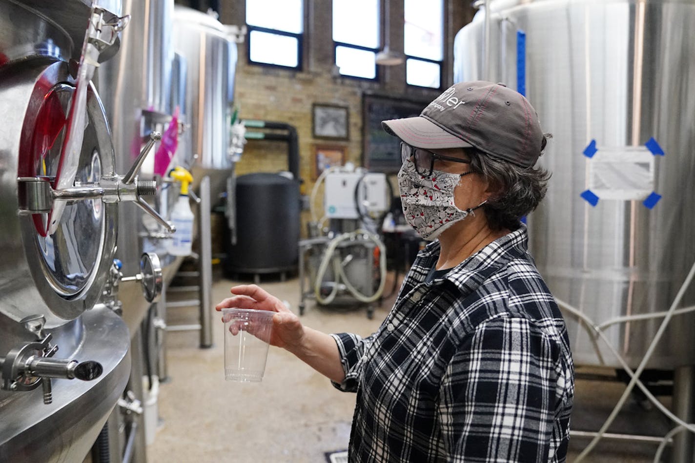 Deb Loch, master brewer and co-owner of Urban Growler Brewing Co., took a sample from one of the tanks Wednesday afternoon. ] ANTHONY SOUFFLE • anthony.souffle@startribune.com