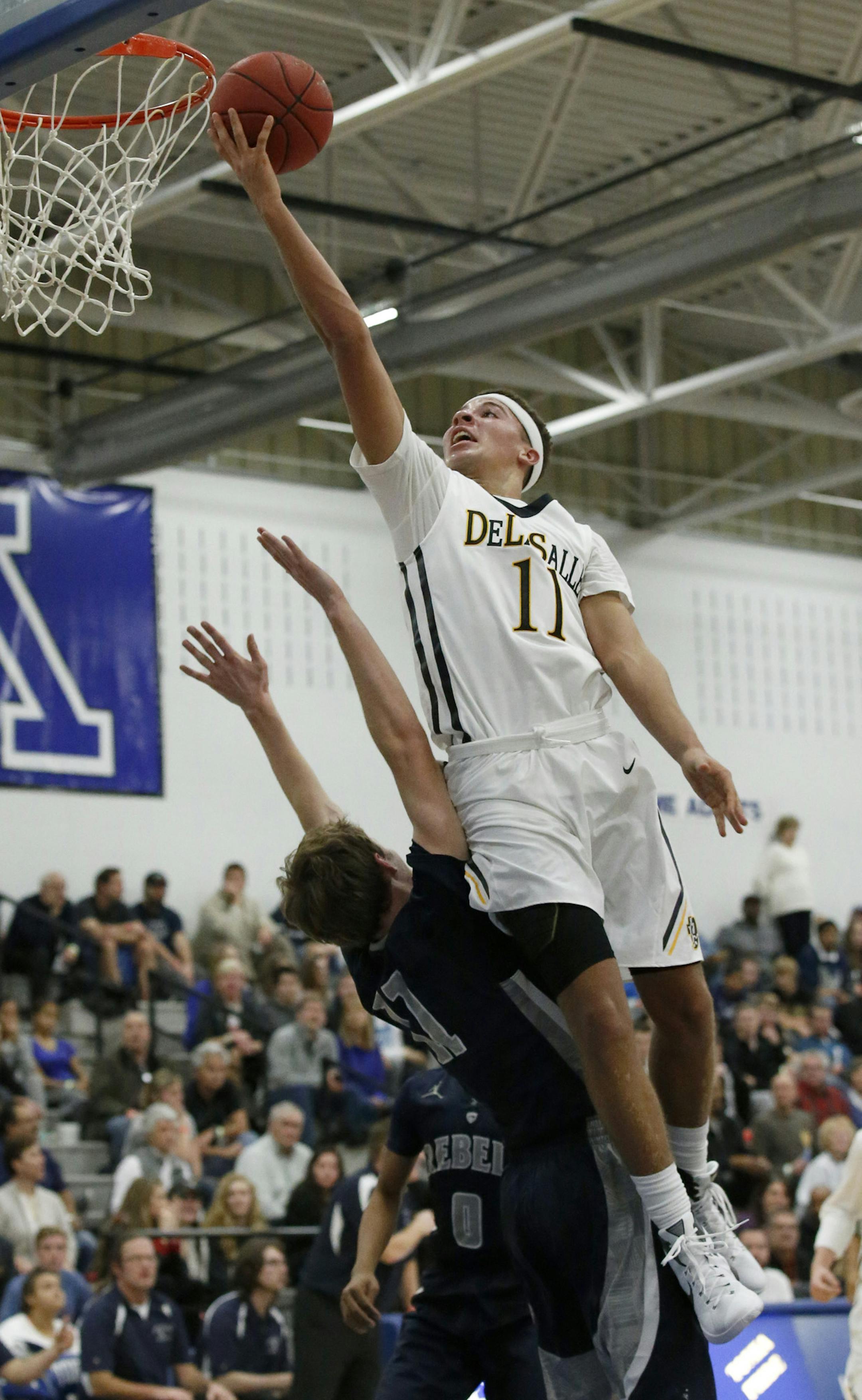 DeLaSalle guard Max Flemming, top, goes up over Champlin Park forward Aaron Kloeppner, bottom, for a shot during the first half in Minnetonka, Saturday, Dec. 12, 2015. ( Photo/Ann Heisenfelt) ORG XMIT: 596959 PREP121315 16