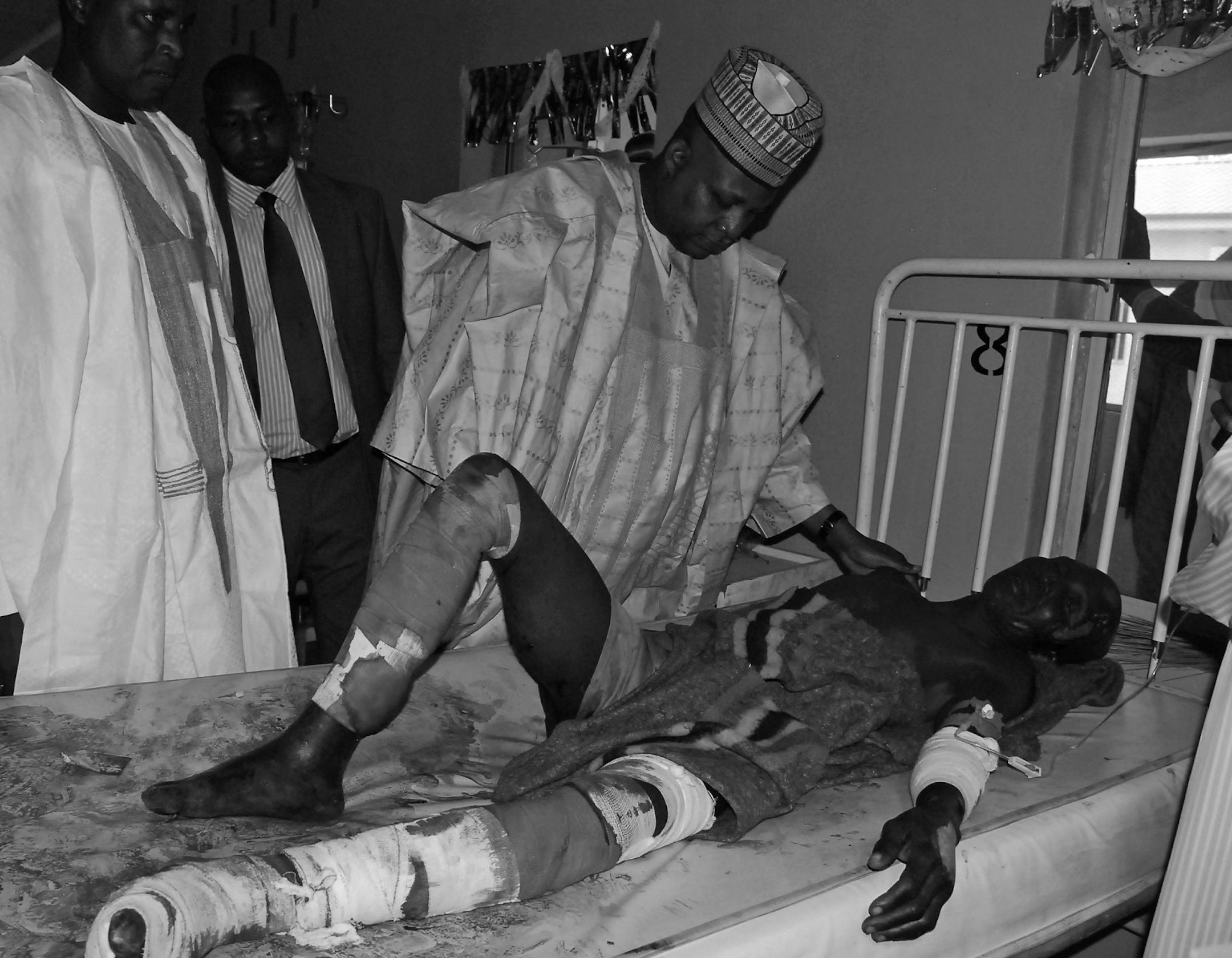 Borno state governor Kashim Shettima, speaks to a victim of suicide bomb attack receiving treatment at a specialist hospital in Maiduguri, Nigeria, Tuesday, Nov. 25, 2014. Two female suicide bombers blew themselves up Tuesday in a crowded market in Nigeria√≠s northeastern city of Maiduguri, killing at least 30 people, according to witnesses and a security official. Boko Haram, Nigeria's Islamic extremist rebels, are suspected of the bombings, as they have carried out many similar a