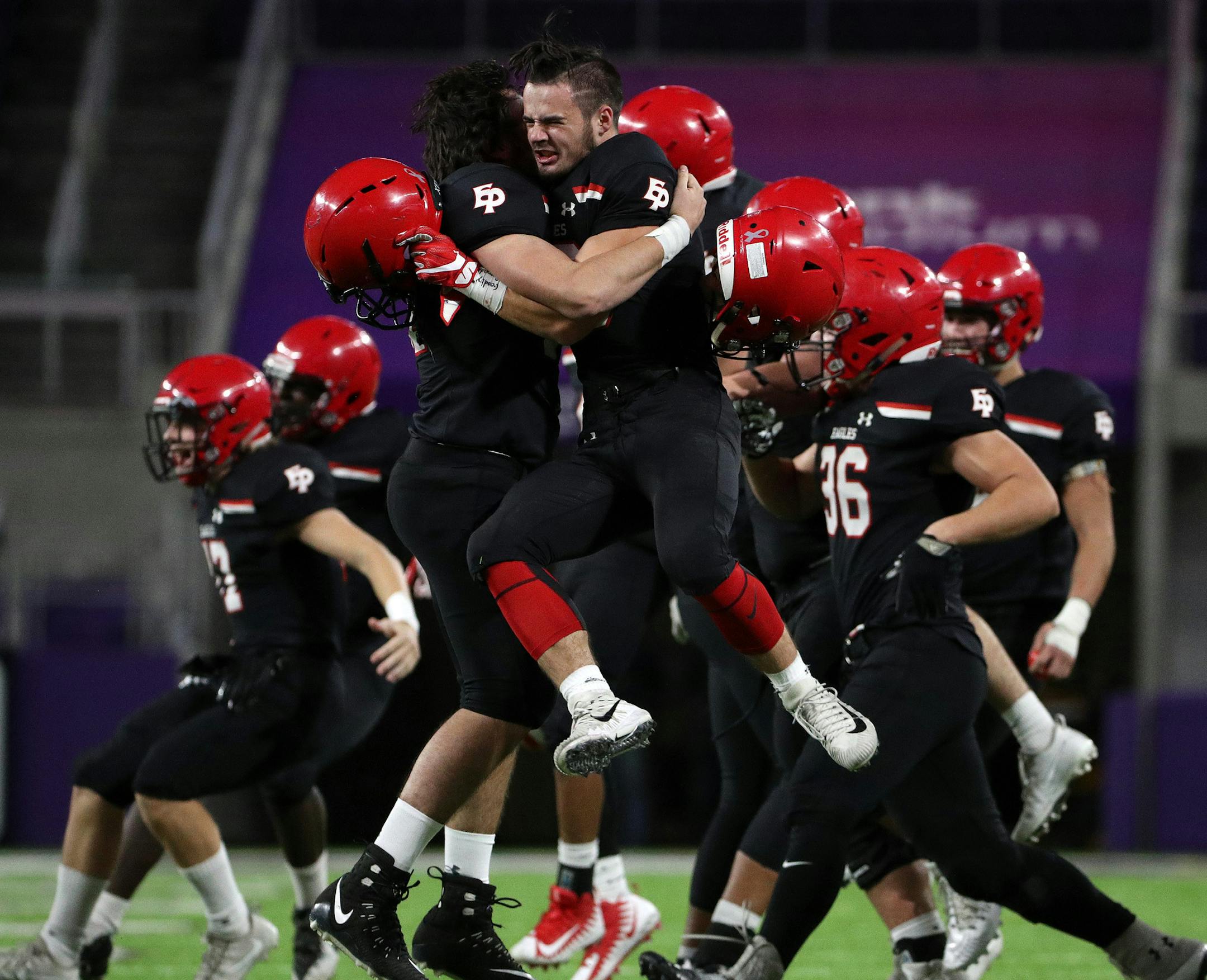 Eden Prairie High School center Zach Miranda (54) celebrated with running back Brandon Enriquez (18) as the team raced onto the field to celebrate after defeating Minnetonka High School. ] ANTHONY SOUFFLE ï anthony.souffle@startribune.com Game action from a Class 6A championship football game between Eden Prairie High School and Minnetonka High School Friday, Nov. 24, 2017 at U.S. Bank Stadium in Minneapolis.