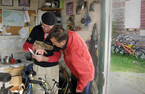 Tom Hart, left, owner of the Bayfield Bike Route, directs cyclist to the best bike trails in the Bayfield area.