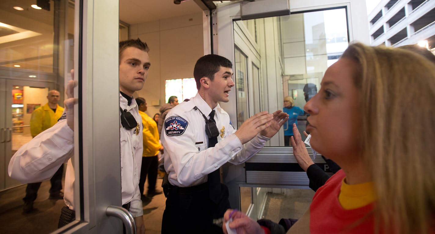 Shoppers hoping to get into Mall of America confront security guards who shut down entrances on the east side due to a Black Lives Matter protest. ] AARON LAVINSKY &#xac;&#x2022; aaron.lavinsky@startribune.com Black Lives Matter protestors demonstrate at Mall of America Saturday, Dec. 20, 2014 in Minneapolis. ORG XMIT: MIN1412201731410072