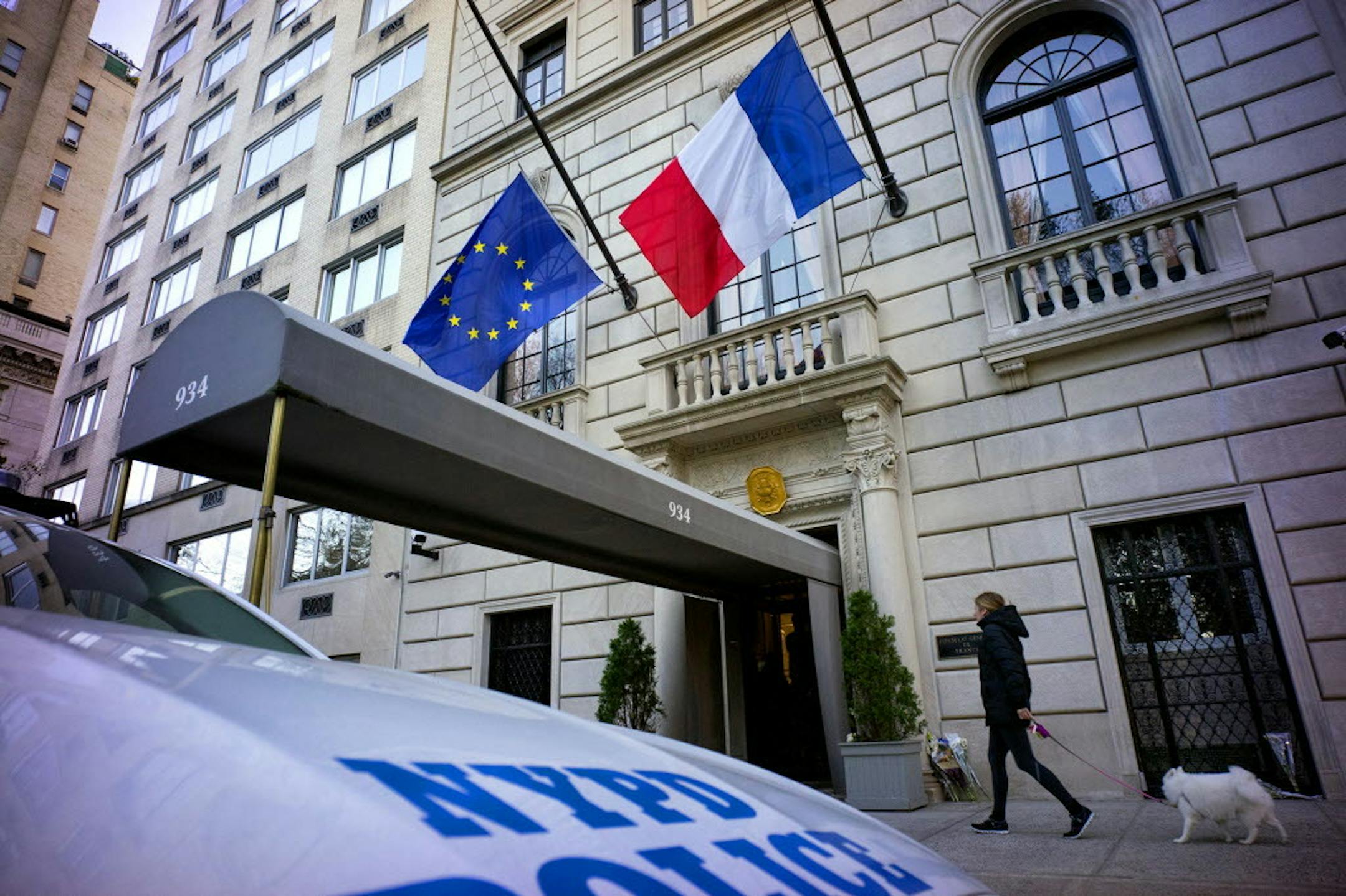 Lowered flags wave in the breeze at the French consulate in New York on Saturday.
