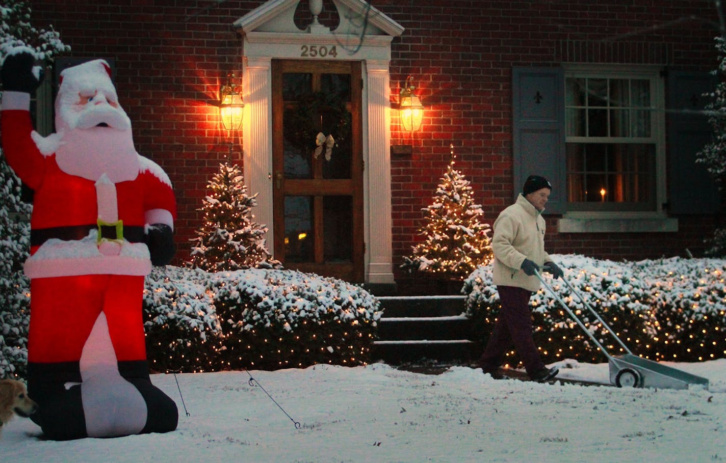 Jim Shaughnessy clears his walkway of the overnight Christmas snow at first light to prepare for the arrival of relatives at his home in Louisville, Ky. on Saturday, Dec. 25, 2010. (AP Photo/The Courier-Journal, Michael Hayman) NO SALES; MAGS OUT; NO ARCHIVE; MANDATORY CREDIT