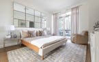 Mirrors hung in a grid act like visual windows in this master bedroom. (Design Recipes/TNS)