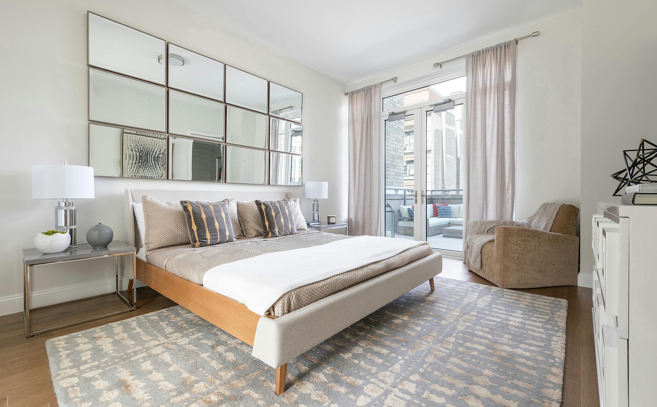 Mirrors hung in a grid act like visual windows in this master bedroom. (Design Recipes/TNS)