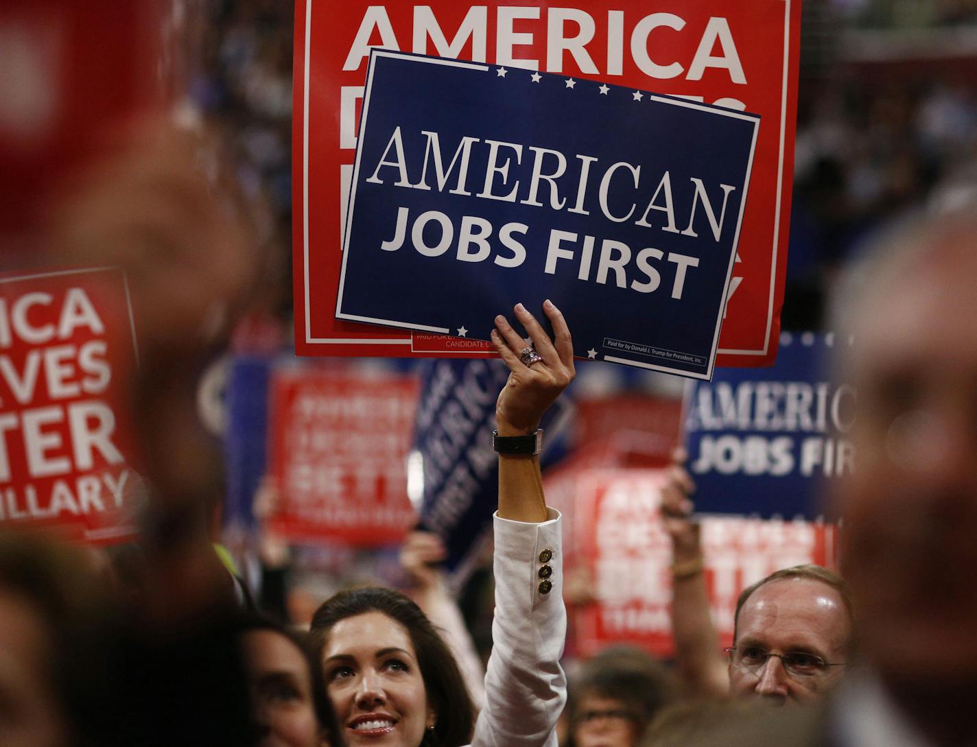 Delegates hold signs during the Republican National Convention in Cleveland on July 20, 2016. MUST CREDIT: Bloomberg photo by Andrew Harrer.