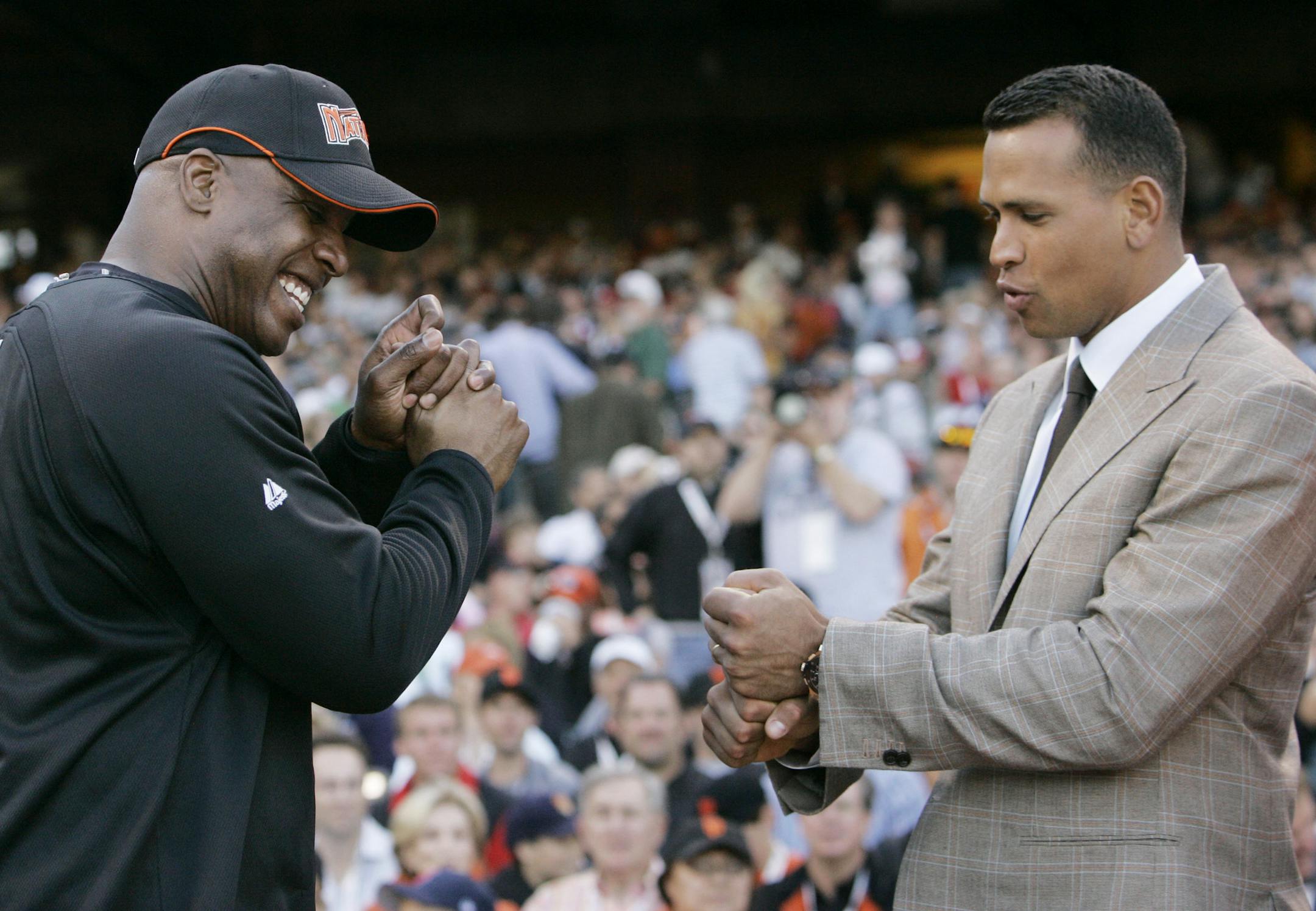 FILE - In this July 9, 2007, file photo, American League's Alex Rodriguez, right, of the New York Yankees, compares grips with National League's Barry Bonds, of the San Francisco Giants, during the All-Star Home Run Baseball Derby in San Francisco. Rodriguez is getting hitting tips from Bonds as the Yankees third baseman prepares to return from a season-long suspension. Rodriguez spokesman Ron Berkowitz confirmed the workouts, which the San Francisco Chronicle reported Wednesday, Jan. 21, 2015,