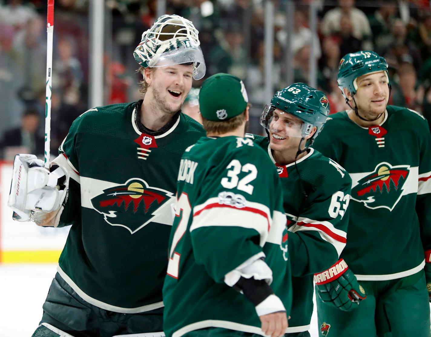 Wild goaltender Devan Dubnyk (40) celebrates the 4-2 win with teammates including Tyler Ennis (63)