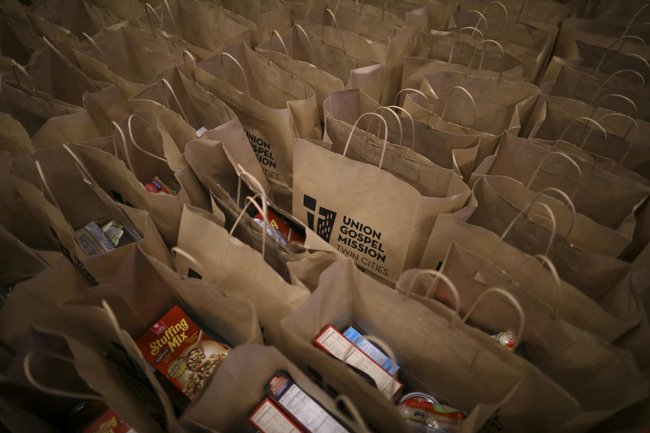 Some of the thousands of grocery bags packed by volunteers at the Union Gospel Mission, each containing all the fixings, that when combined with the turkeys also distributed, make a complete Thanksgiving meal.